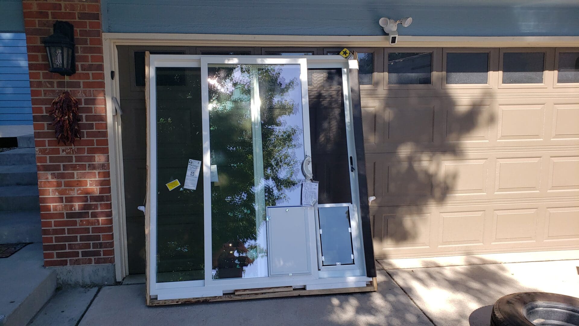 A sliding glass door that is broken in half.